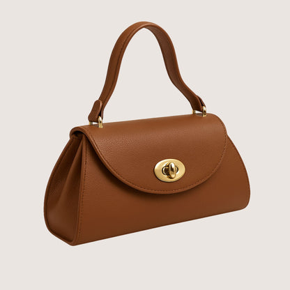 Florence top-handle bag in Cuoio Soft Togo leather, warm caramel-brown hue, shown from a side angle to highlight the sculptural silhouette.