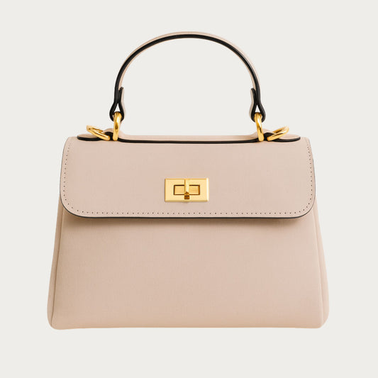 Mimi structured top-handle bag in powder pink Italian suede with gold hardware, front view.