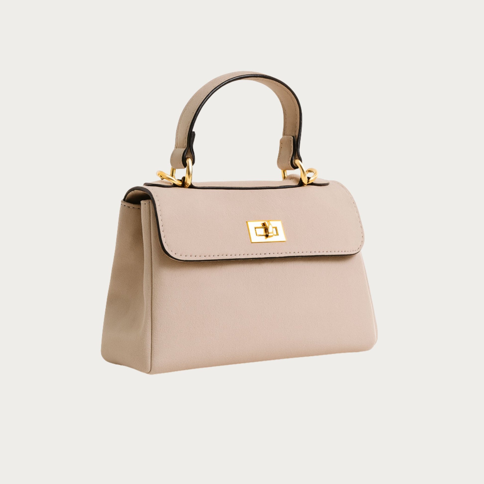 Side view of the Mimi structured top-handle bag in powder pink suede, showing its sculpted silhouette.