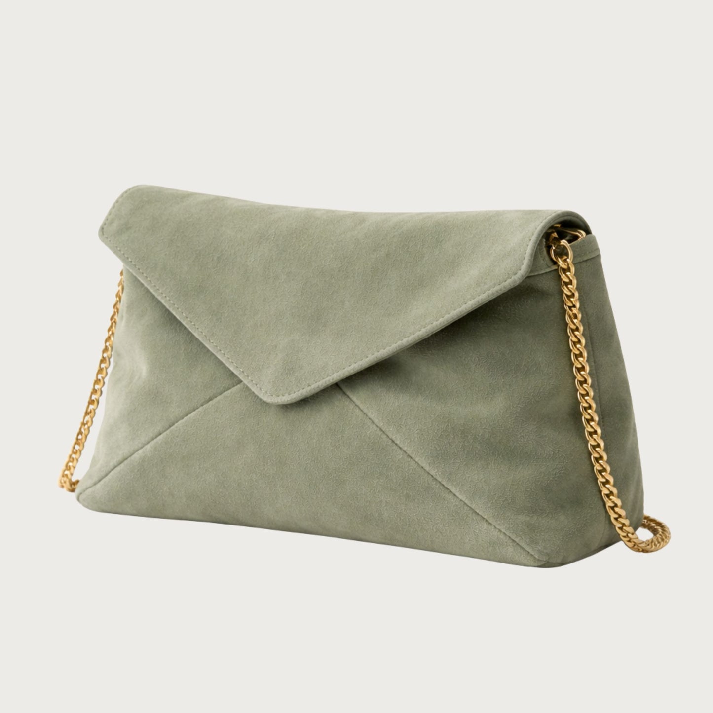 Side view of the Nina convertible clutch in muted sage-green suede with removable gold chain.