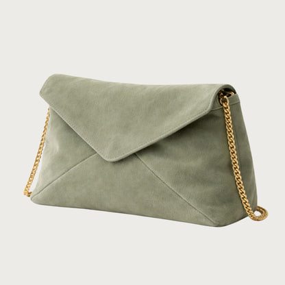 Side view of the Nina convertible clutch in muted sage-green suede with removable gold chain.