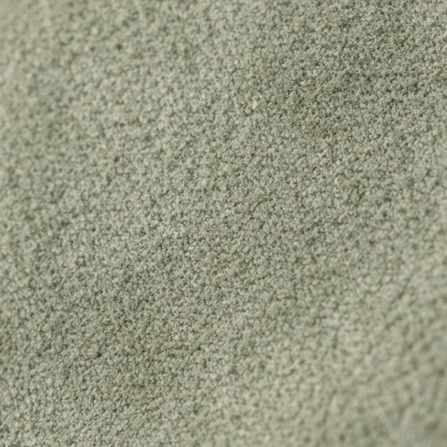 Macro texture detail of the Nina convertible clutch in muted sage-green suede.