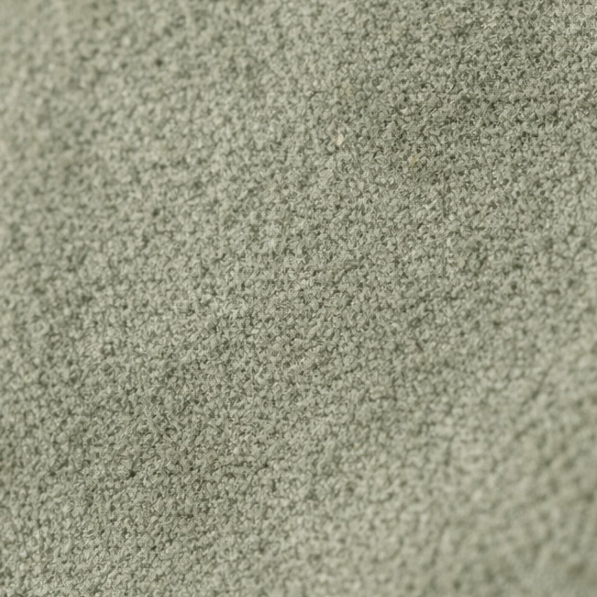 Macro texture detail of the Nina convertible clutch in muted sage-green suede.